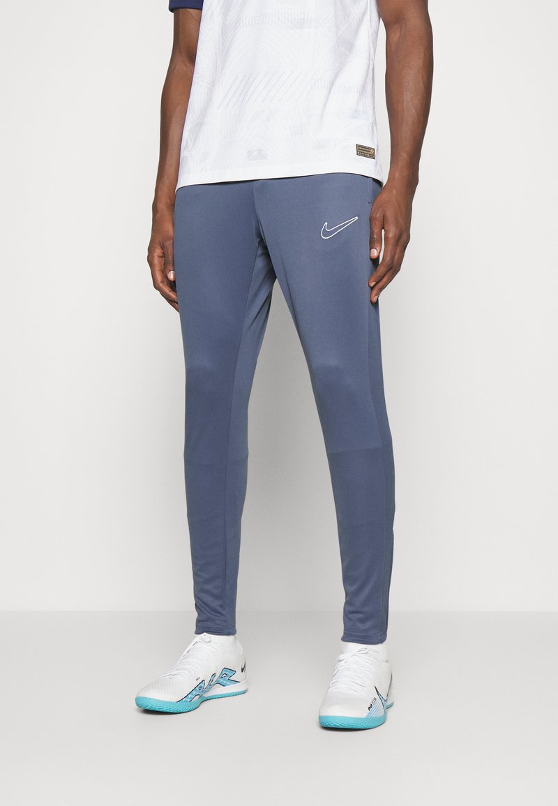 Men’s Long trousers | Nike Performance ACADEMY 23 PANT BRANDED – Tracksuit bottoms – diffused blue/diffused blue/white/blue – FR96773