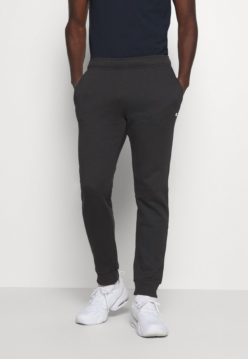 Men’s Long trousers | Champion LEGACY CUFF PANTS – Tracksuit bottoms – black – OH61736